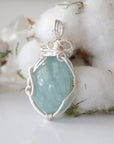 Back angle of aquamarine pendant, highlighting wire wrapped setting and natural stone texture