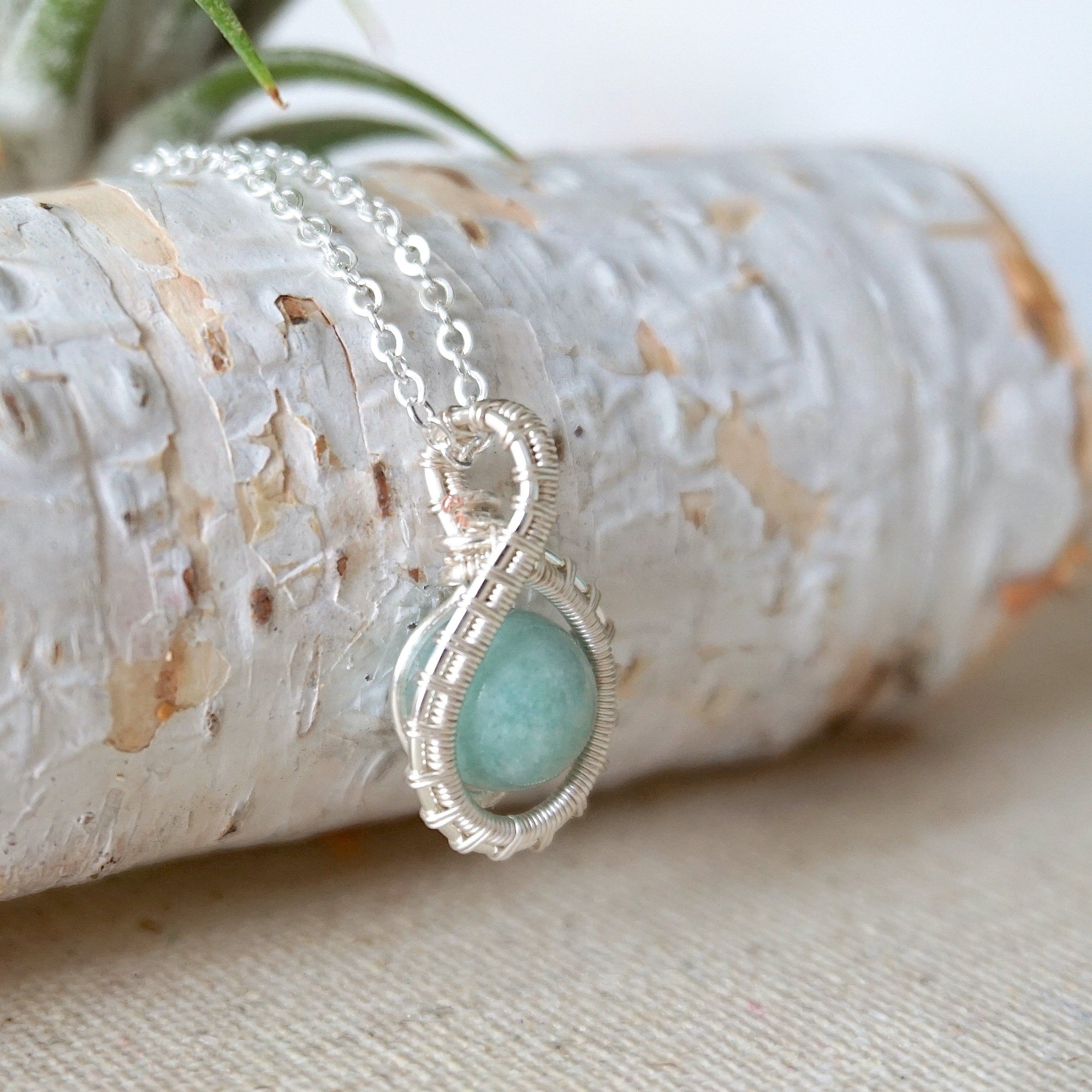 Right side angle of aquamarine necklace for women, artisan wire wrapped, soft silver finish