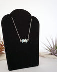 Right angle view of aquamarine and freshwater pearl bar necklace in 925 sterling silver on jewelry display