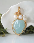 Detailed front angle of aquamarine and freshwater pearl pendant, gold wire wrapped, handcrafted gemstone jewelry
