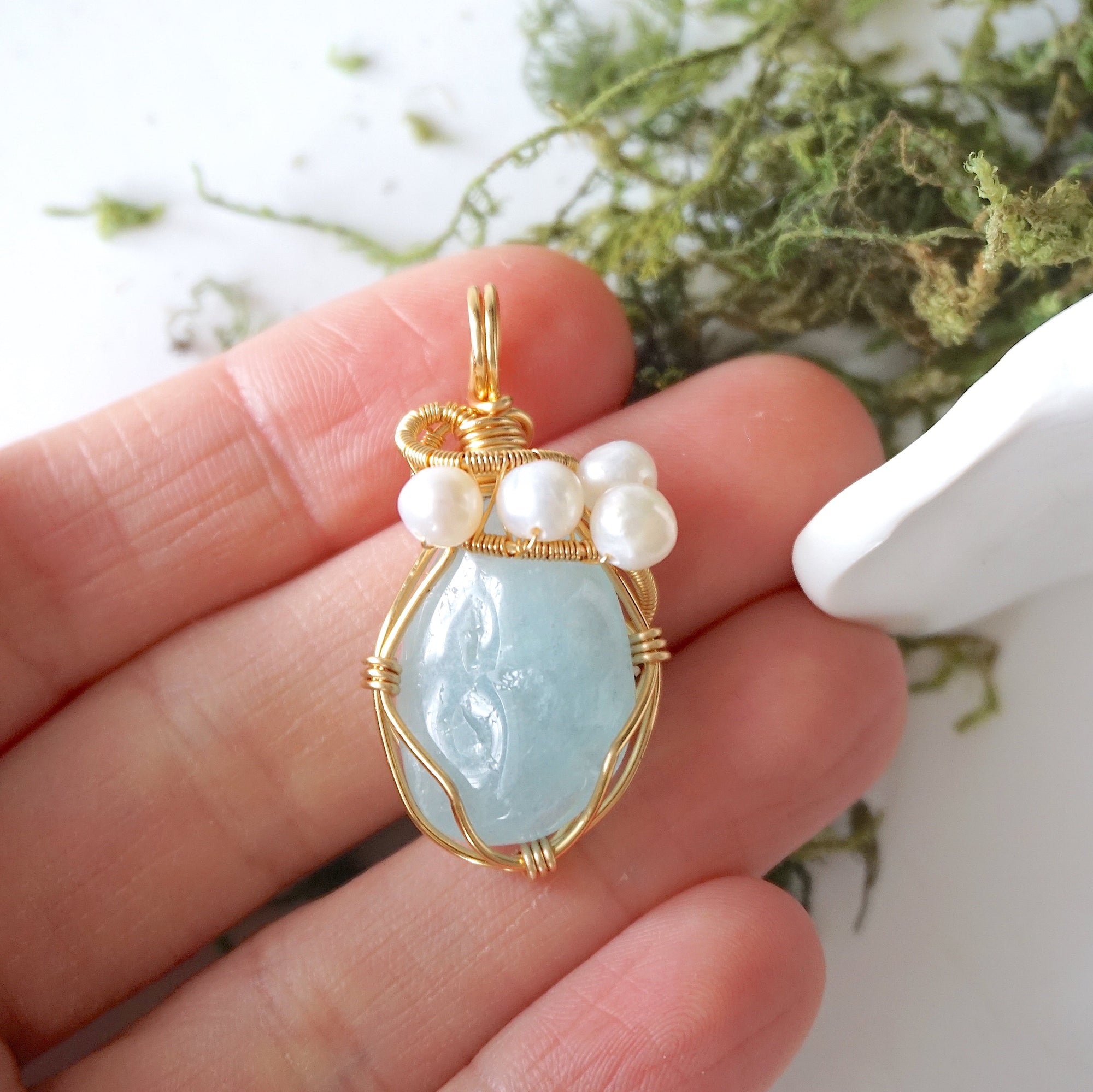 Aquamarine and freshwater pearl necklace pendant in hand for size reference, artisan birthstone jewelry gift for her