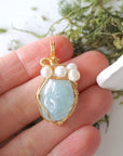 Aquamarine and freshwater pearl necklace pendant in hand for size reference, artisan birthstone jewelry gift for her