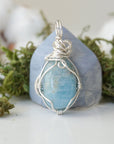 Back view of aquamarine pendant, genuine polished stone with handcrafted silver wire