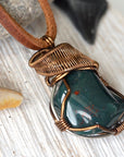 Detailed side angle of natural bloodstone necklace, artisan wire wrapped pendant by Designs by Nature Gems.