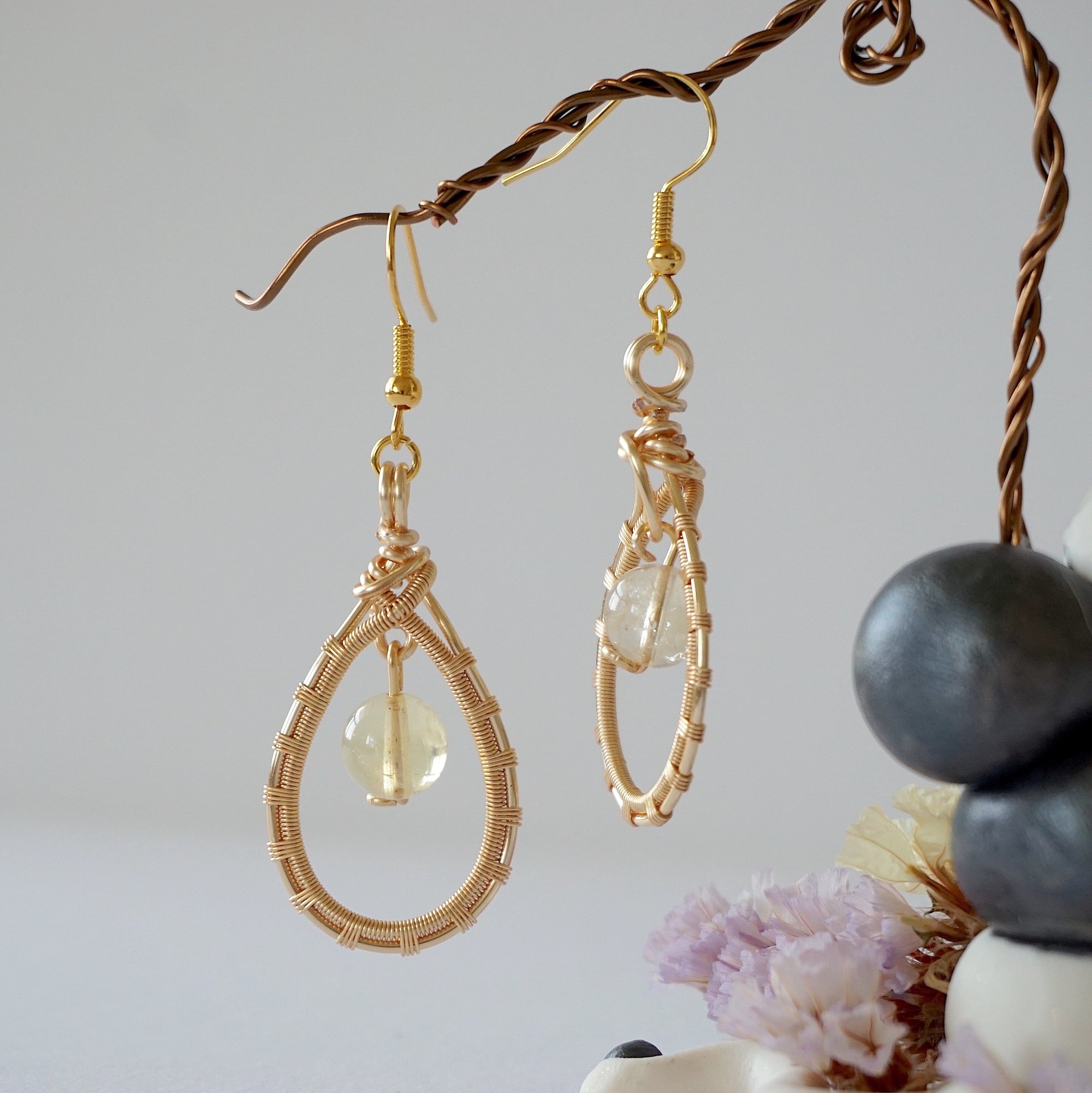 Close up wire detail of natural citrine crystal earrings- handmade drop earrings showing artisan craftsmanship and golden stone