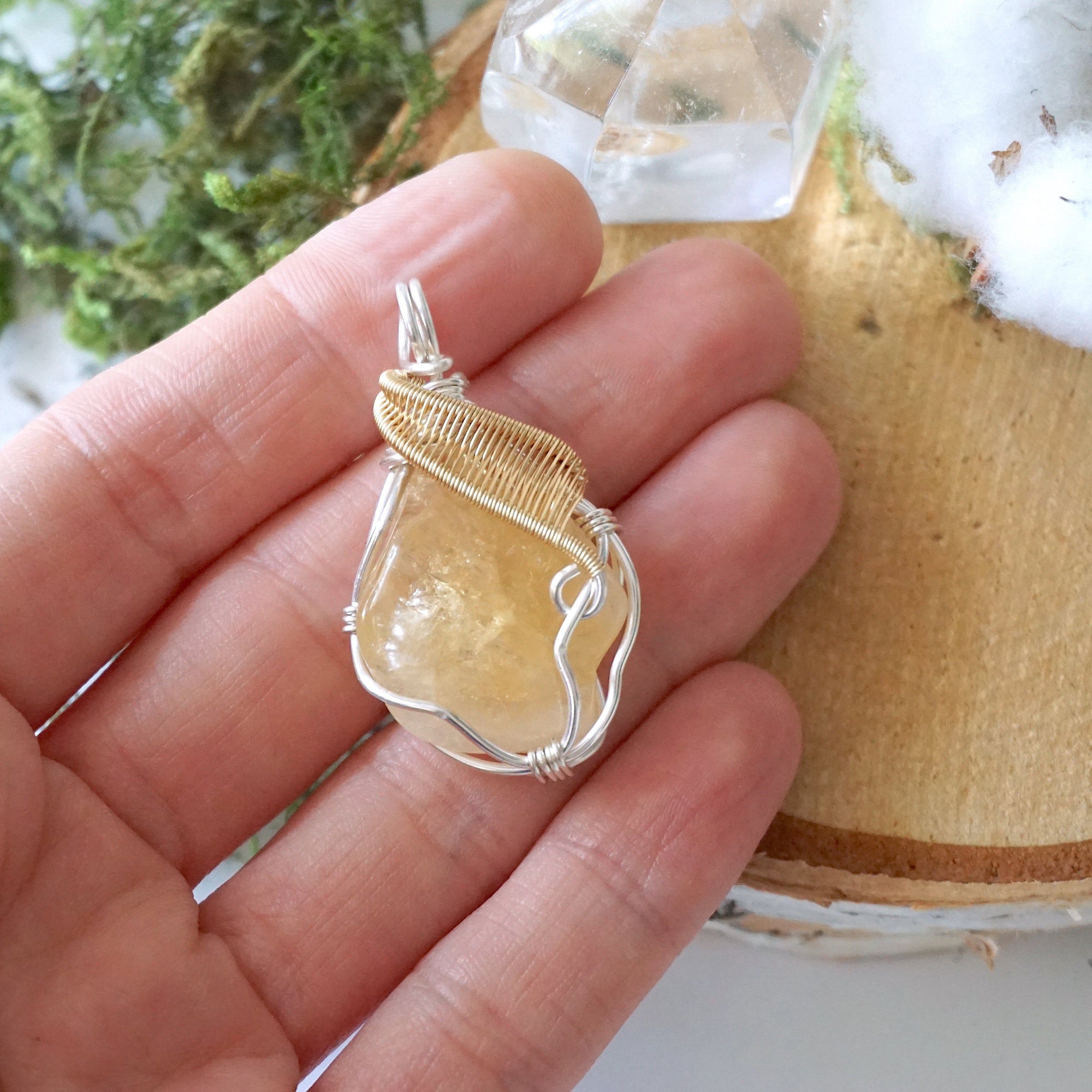 Raw citrine necklace size comparison in hand showing pendant dimensions - handcrafted silver gold wire wrapped crystal jewelry