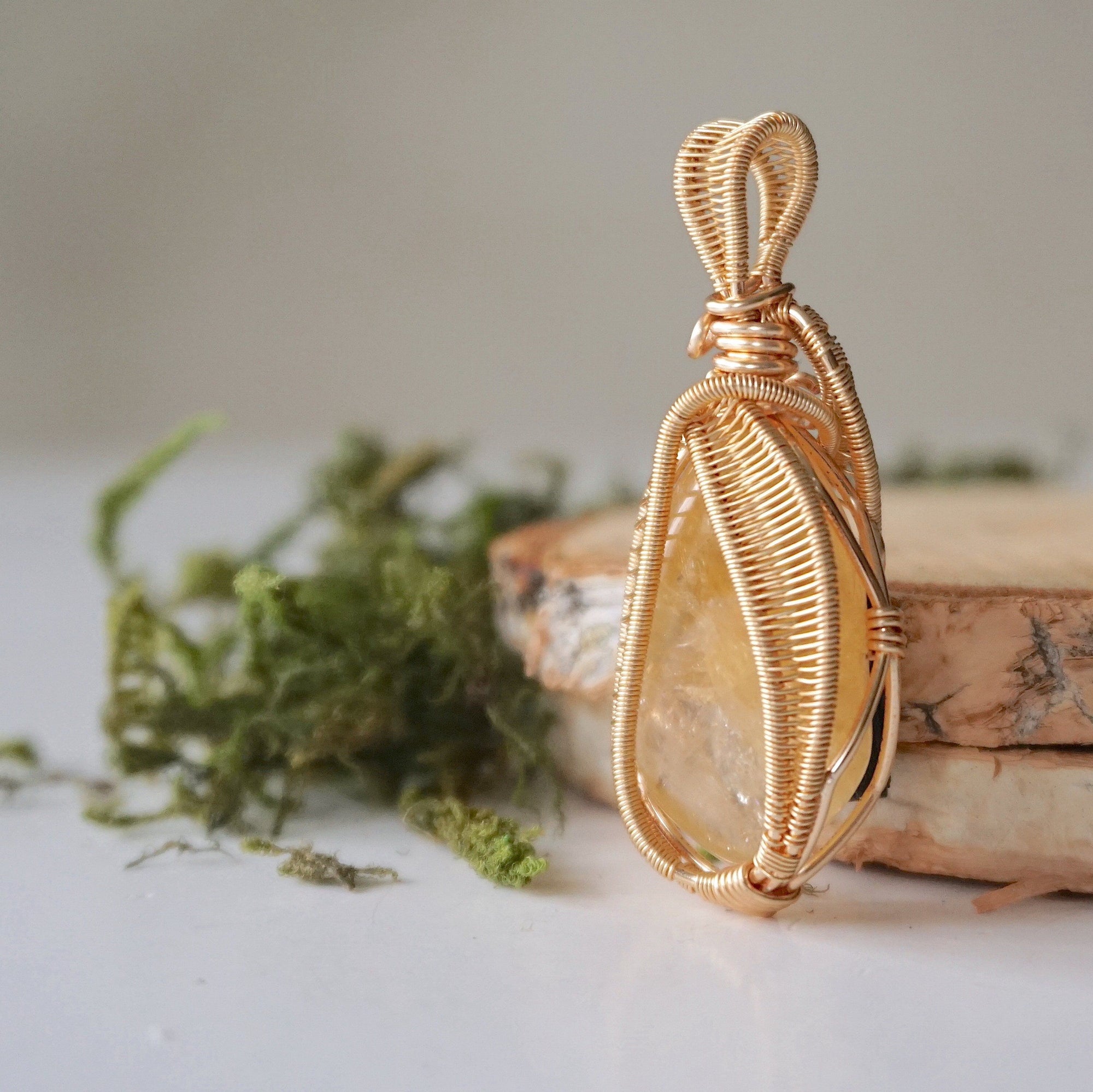 Side angle close-up of citrine pendant gold showing detailed wire wrapping craftsmanship November birthstone jewelry
