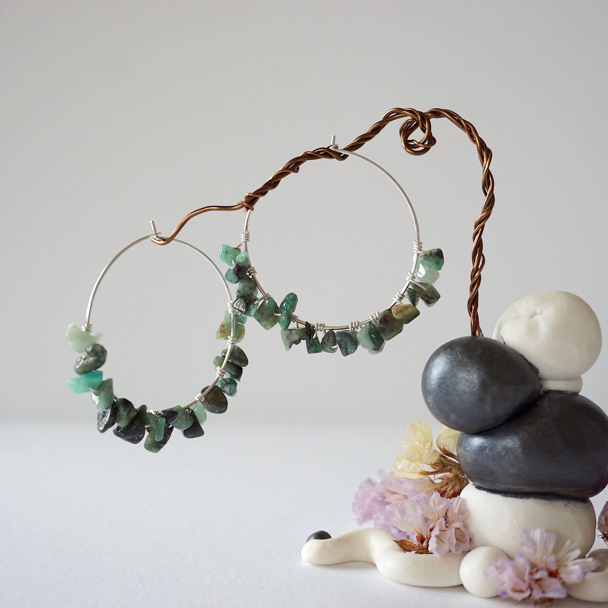 Wire wrapped emerald hoop earrings in soft silver copper with natural emerald chips, detailed artisan jewelry view