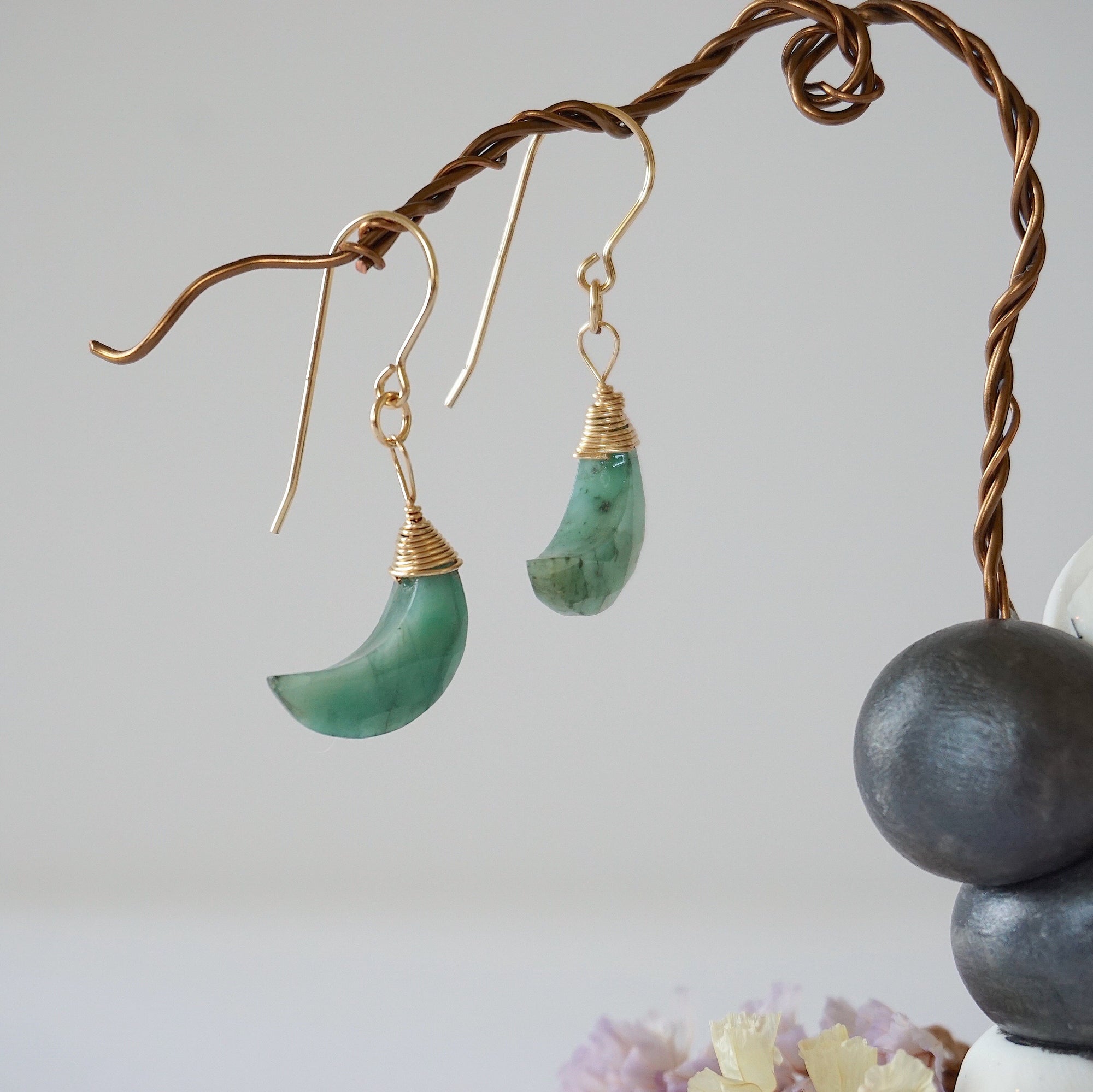 Front view of emerald moon drop earrings in 14k gold filled with natural faceted crescent moon emeralds.