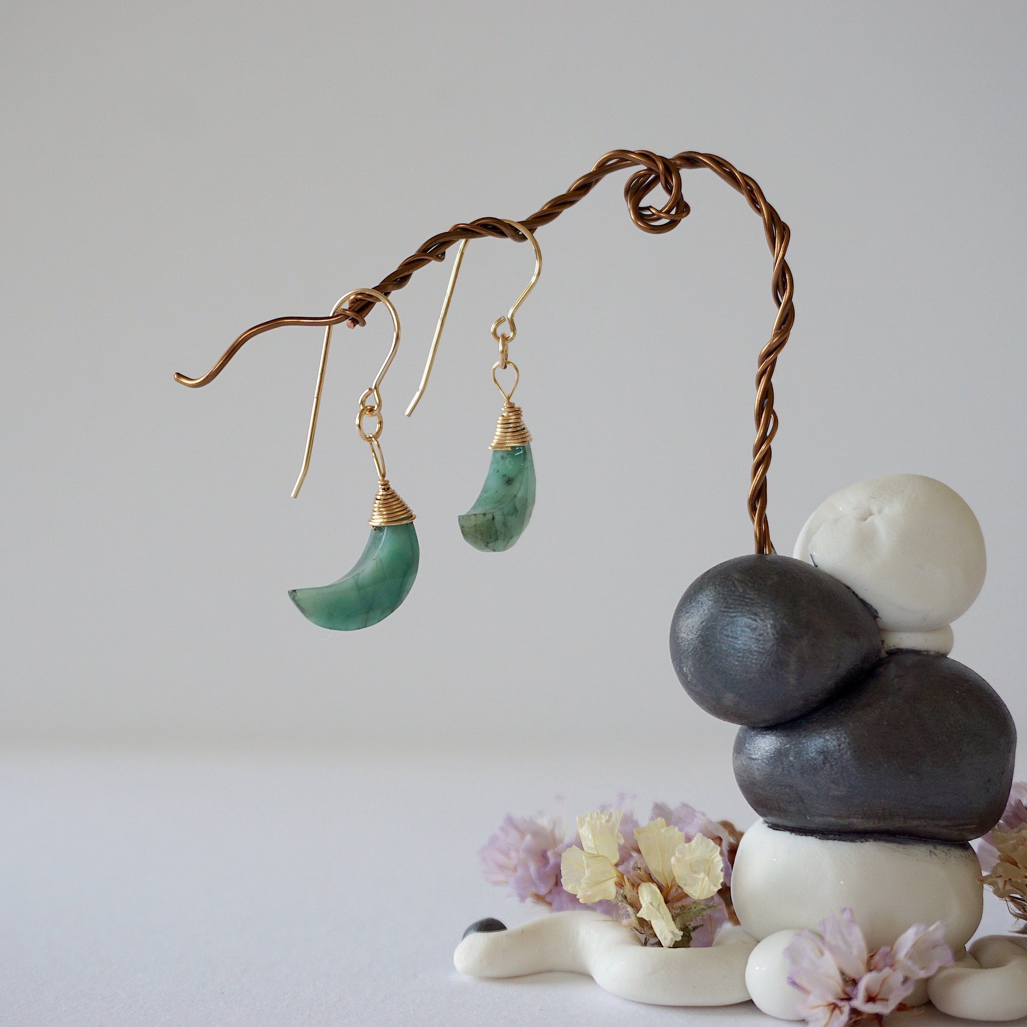 Zoomed out front view of emerald moon drop earrings in 14k gold filled with natural faceted emerald stones.