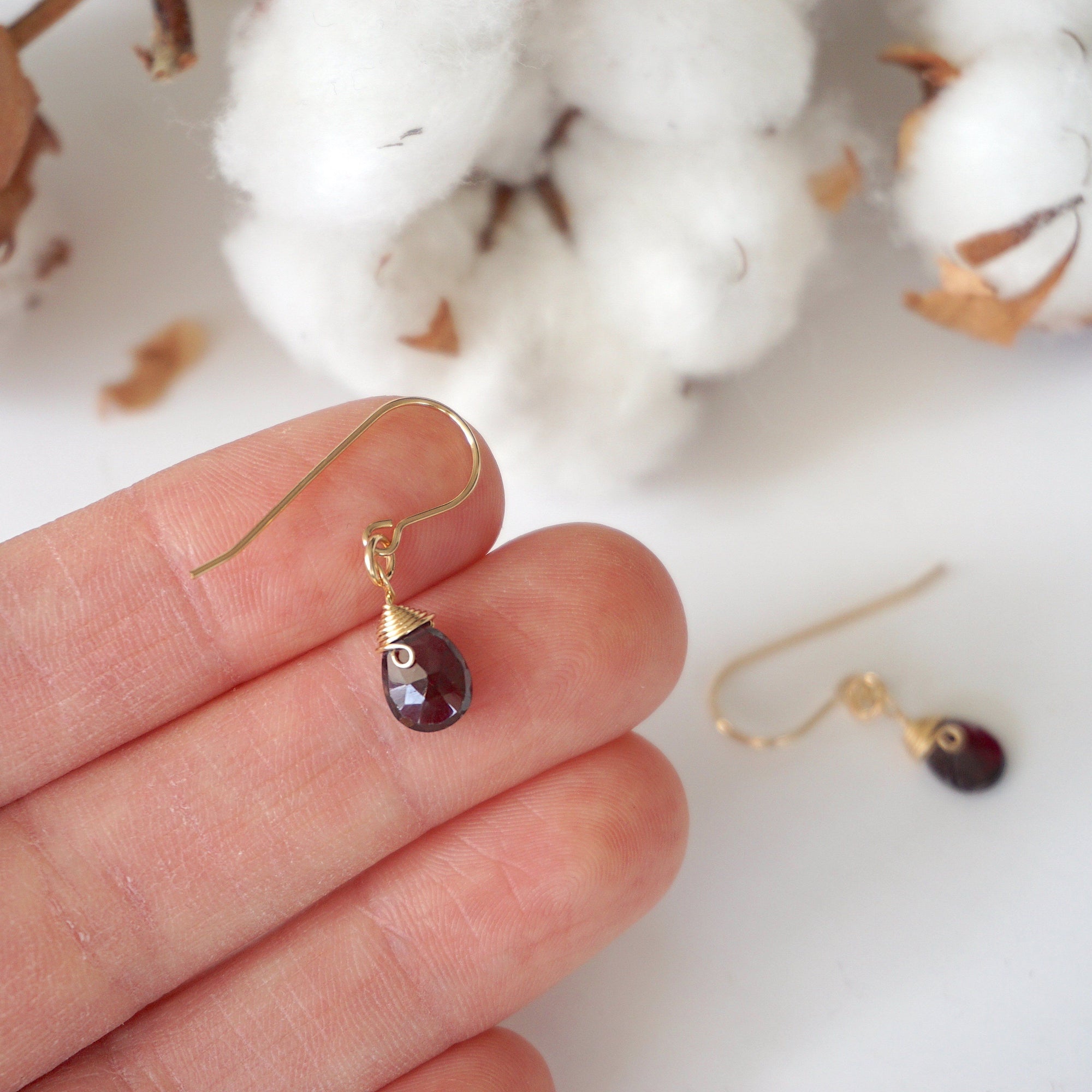 Garnet 14k gold filled drop earrings held in hand for size reference, lightweight wire wrapped gemstone earrings for women