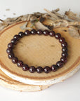Bird’s-eye view of a garnet beaded bracelet showing evenly spaced 8mm garnet beads