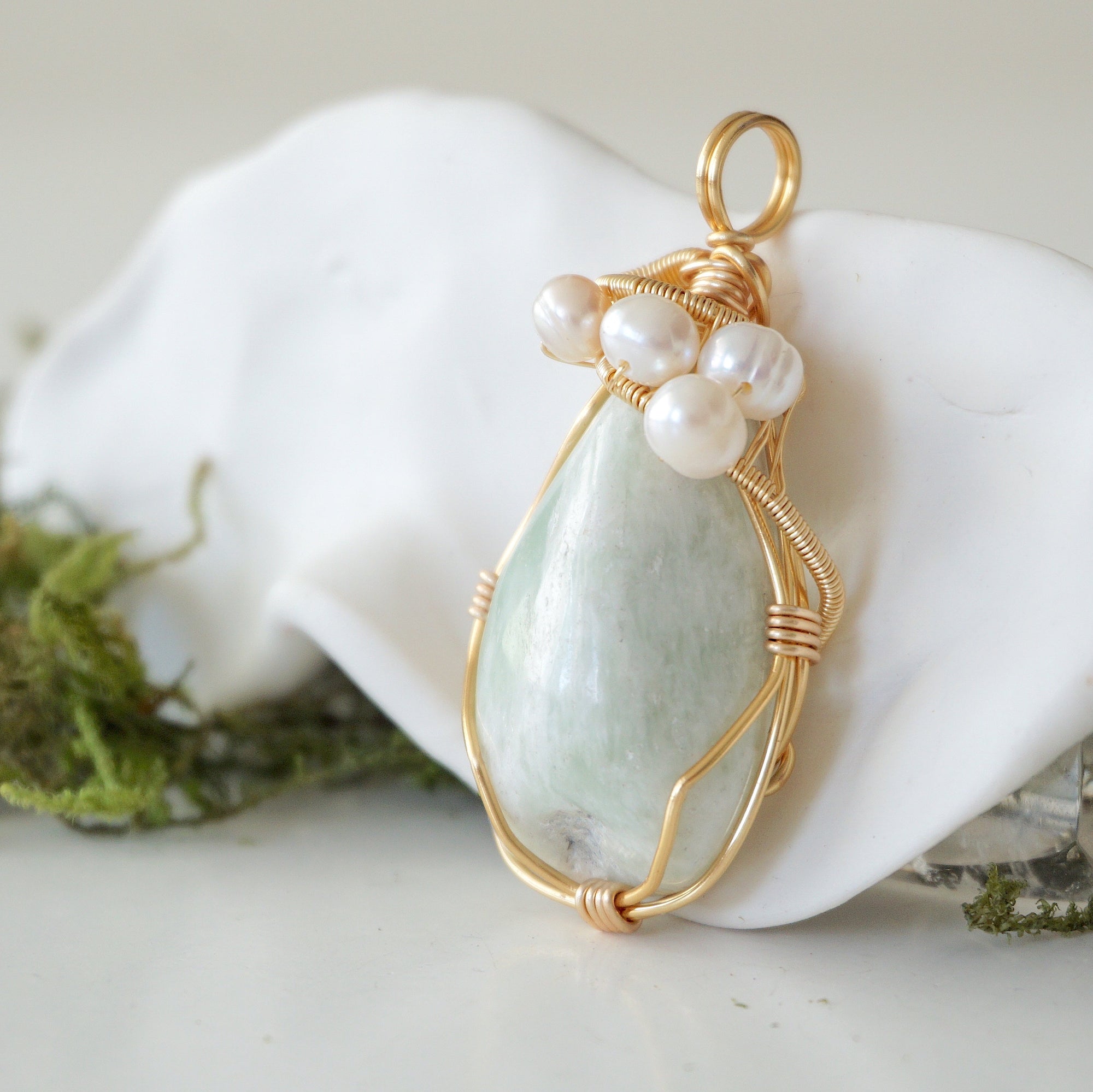Side angle detail of jade and freshwater pearl pendant, gold wire wrapped, ethical artisan necklace