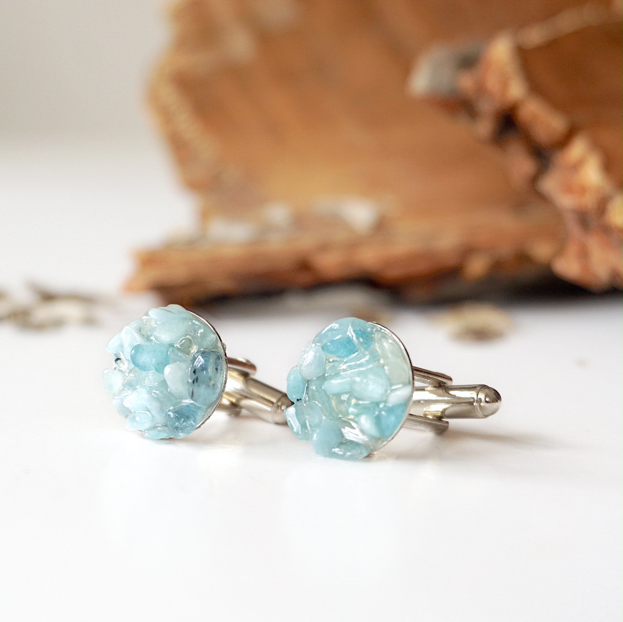 Left side angle of men's aquamarine cufflinks, multiple aquamarines, white gold finish copper