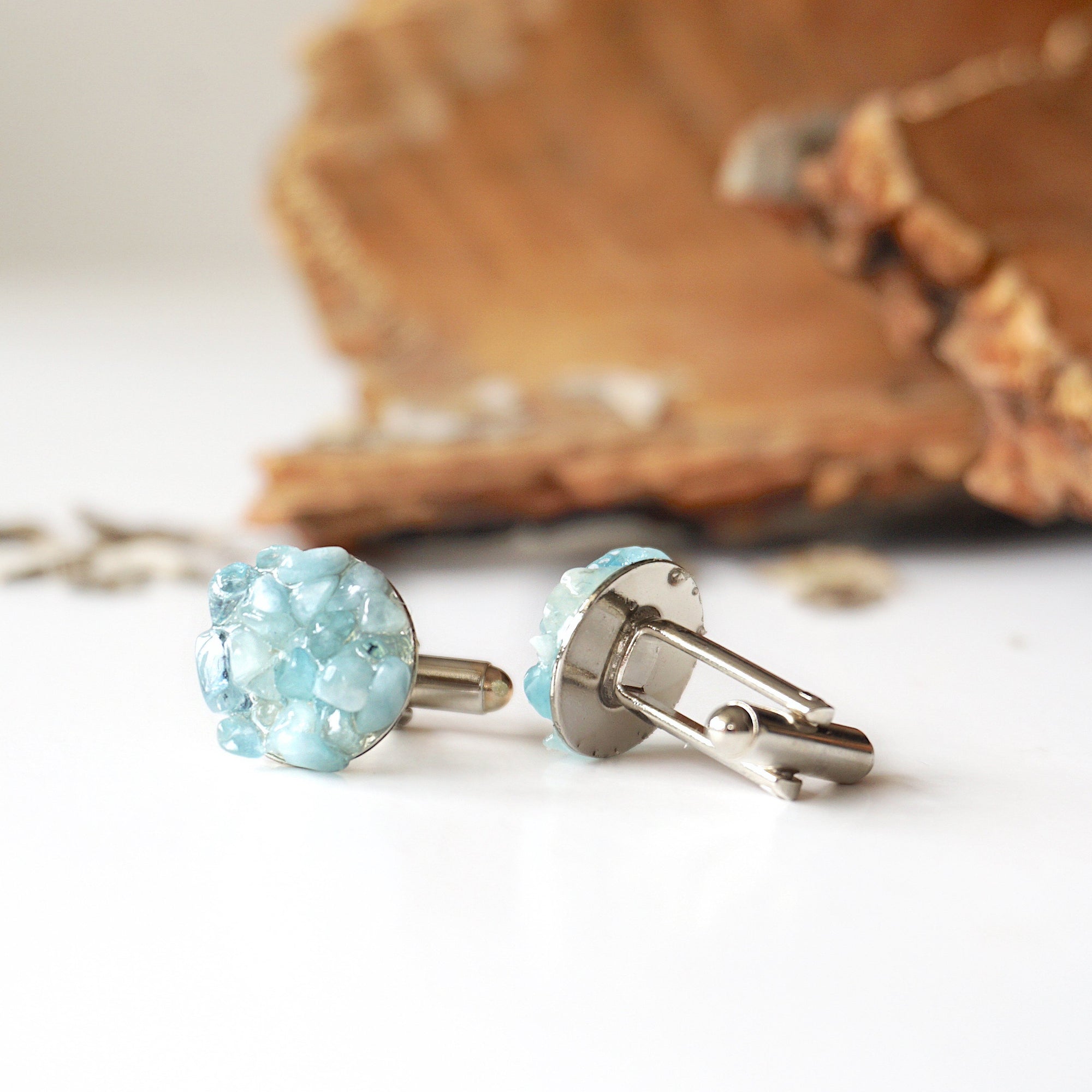 Side profile of men's aquamarine cufflinks, highlighting aquamarine stones and white gold finish copper setting