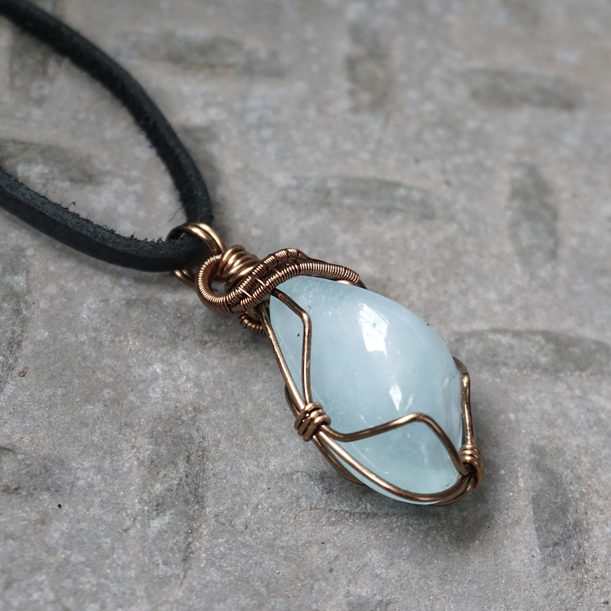 Right side angle of men's aquamarine pendant necklace, genuine aquamarine, antique bronze copper wire wrapping, leather cord