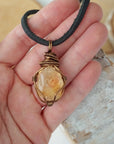 Mens citrine pendant held in hand showing size scale - natural crystal wire wrapped in antique bronze copper handmade masculine necklace size reference