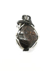 Back view of a men’s wire wrapped garnet pendant necklace showing the secure handcrafted wire work