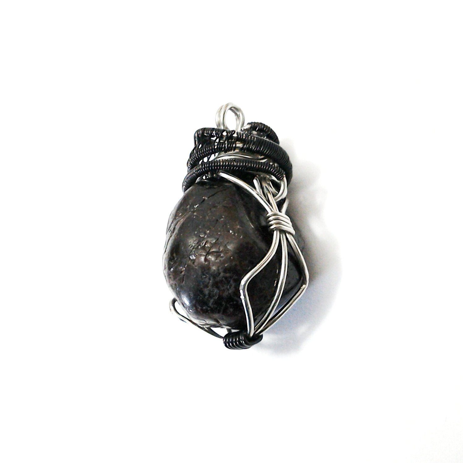 Side view of a men’s wire wrapped garnet pendant showing the mixed tin plated and black copper wire wrapping