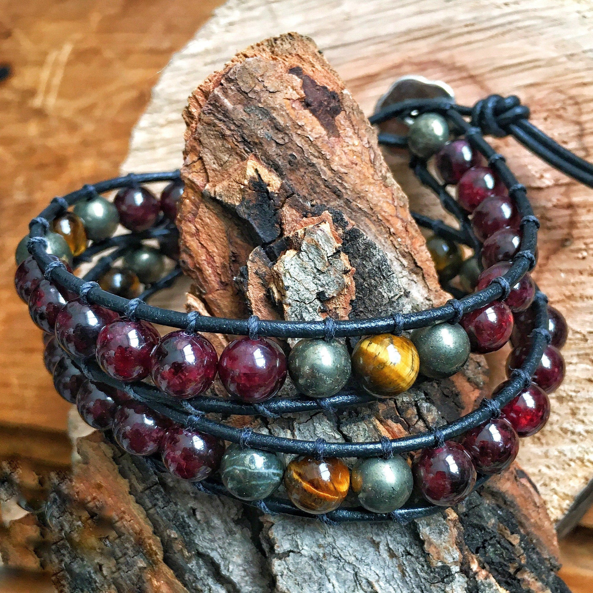 Close-up of garnet, tiger’s eye, and pyrite beads on a handcrafted men’s leather wrap bracelet