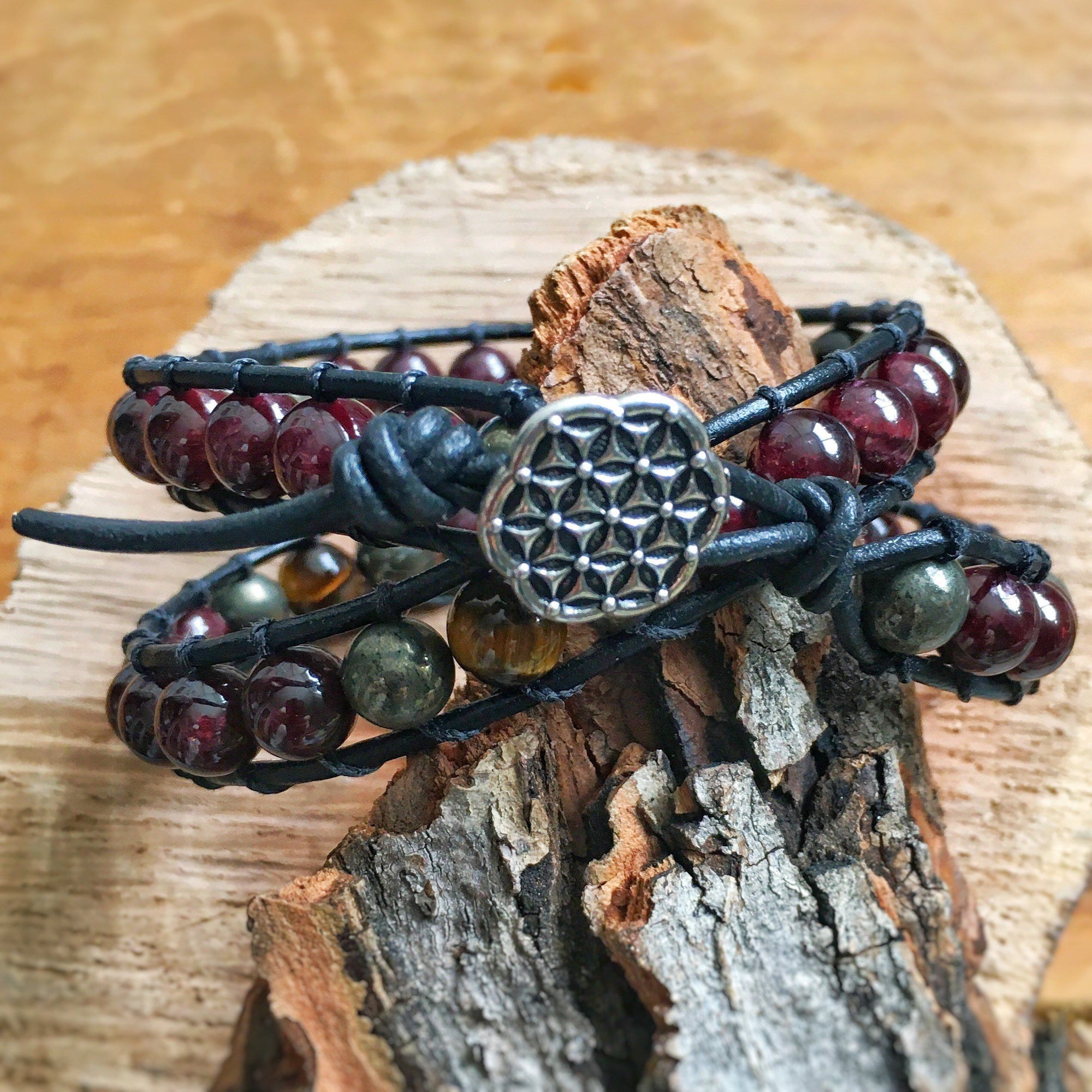 Back view of a men’s leather wrap beaded bracelet showing the Flower of Life button closure and handcrafted leather detailing
