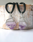 Two men’s raw amethyst pendant necklaces on black leather cord showing natural variation in amethyst size, shape, and color