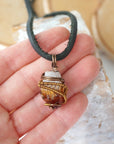 Mens raw citrine pendant held in hand showing size scale - natural unpolished crystal wire wrapped in antique bronze copper masculine necklace size reference