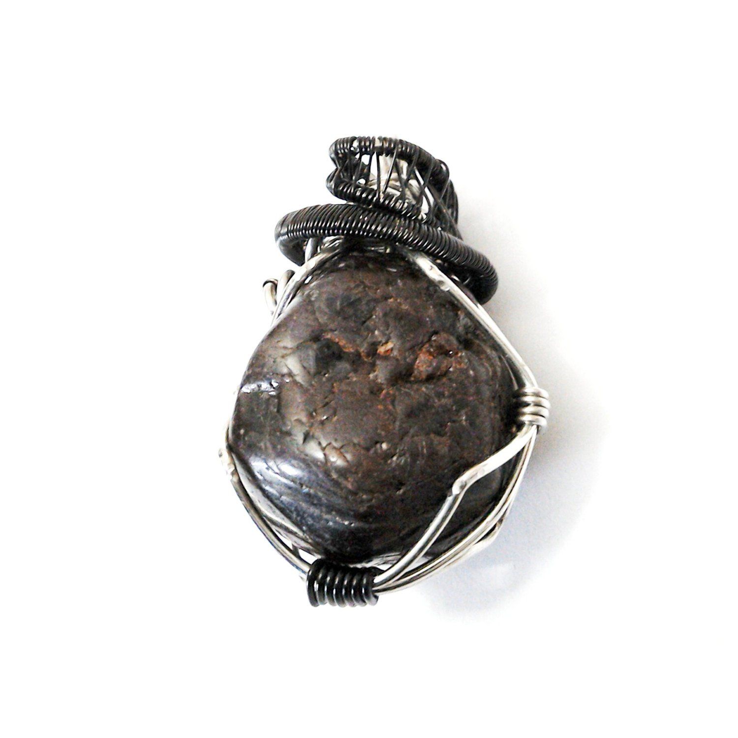 Front view of a men’s wire wrapped garnet pendant necklace featuring a natural garnet wrapped in mixed metal copper wire