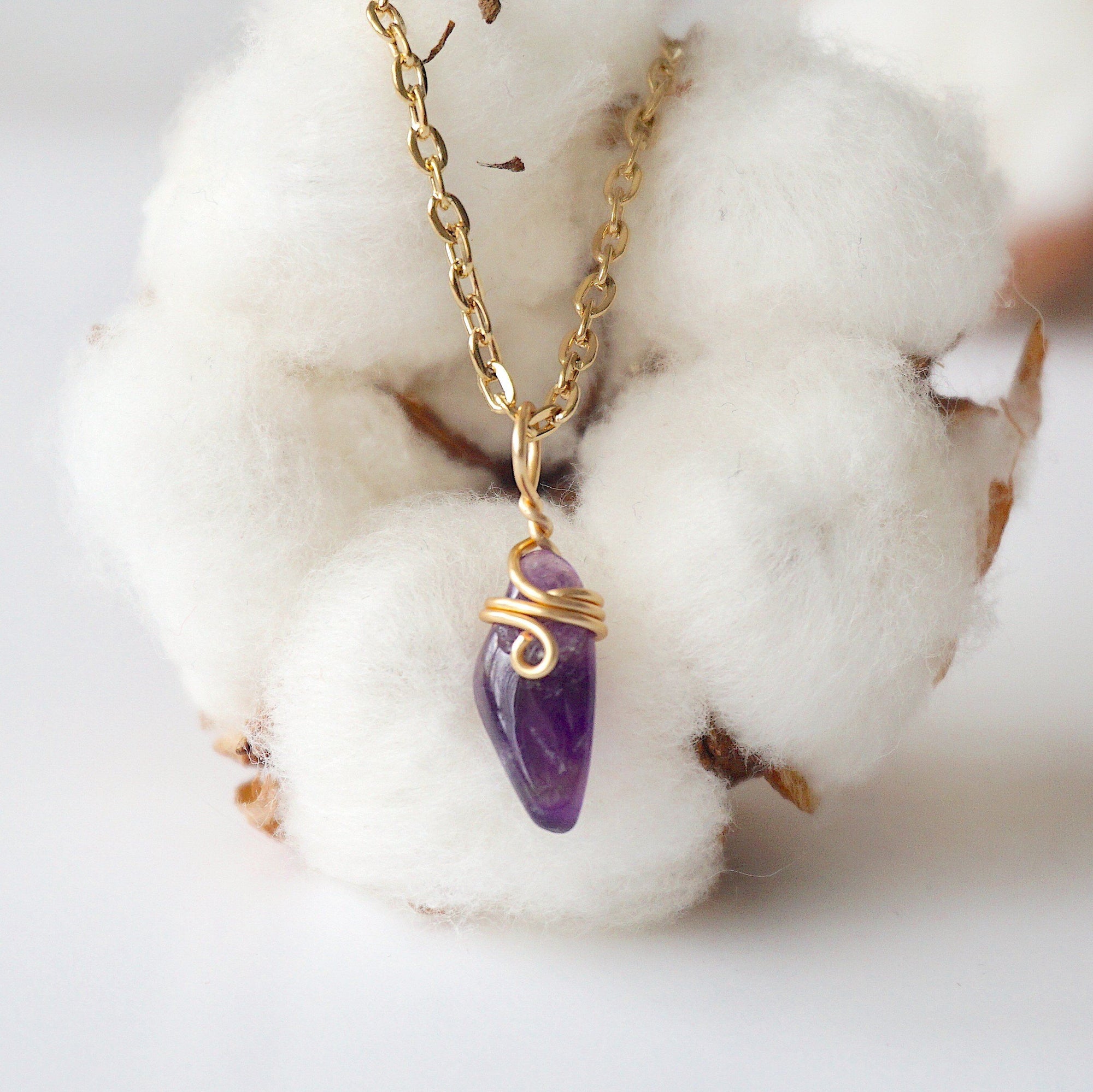 Back side angle of minimalist amethyst necklace, gold plated copper wire wrapped raw amethyst pendant
