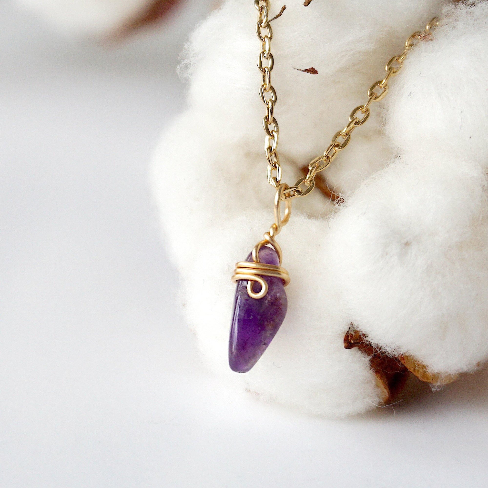Left side angle of minimalist amethyst necklace for women, gold plated copper wire wrapped raw amethyst pendant
