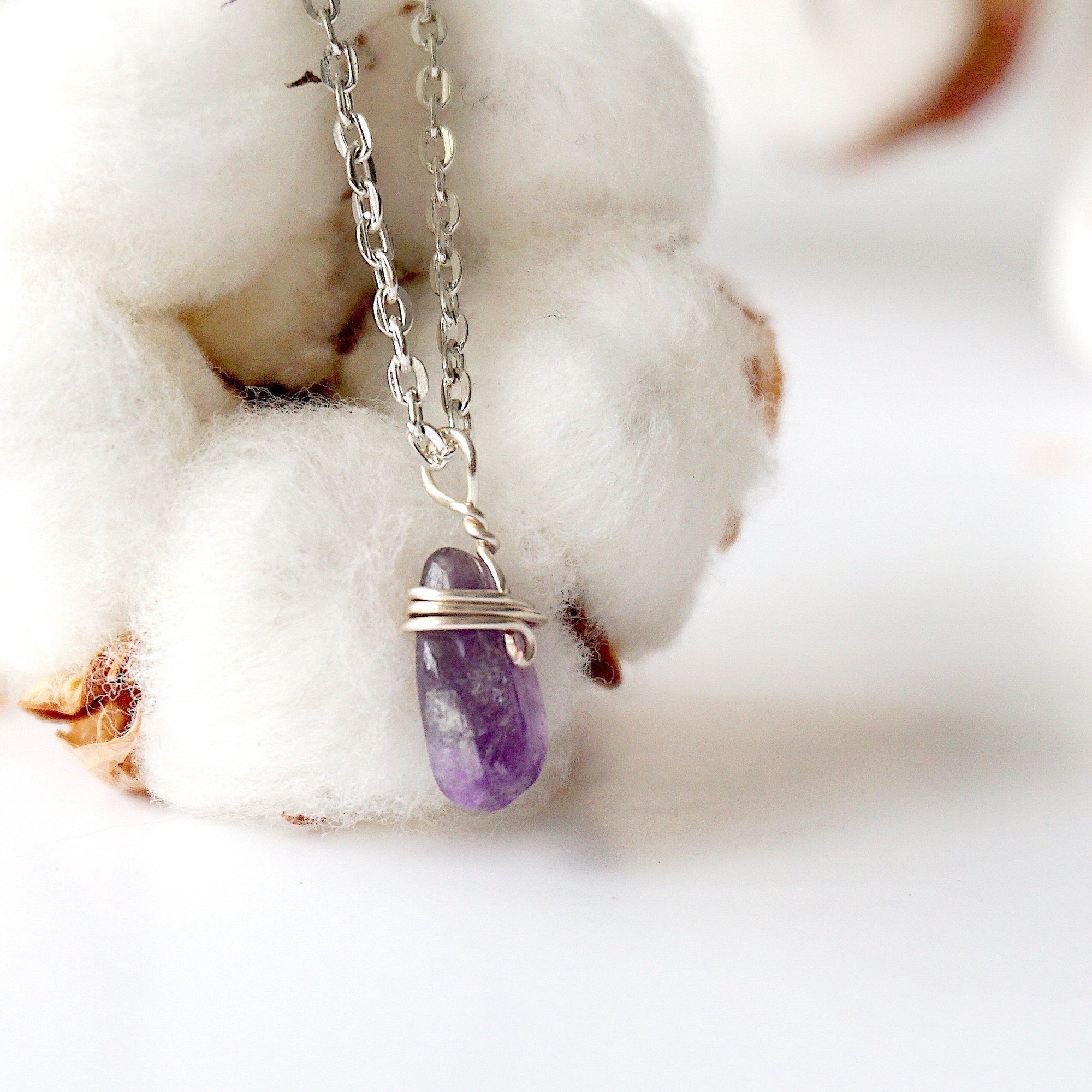 Right side angle of minimalist amethyst necklace, raw amethyst pendant wire wrapped in silver plated copper