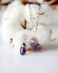 Two minimalist amethyst necklaces showing natural variation in raw amethyst pendant size, shape, and color, silver plated copper wire wrap