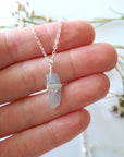 Minimalist aquamarine necklace in a hand for size reference, genuine aquamarine, soft silver artisan wire wrapping, Designs by Nature Gems