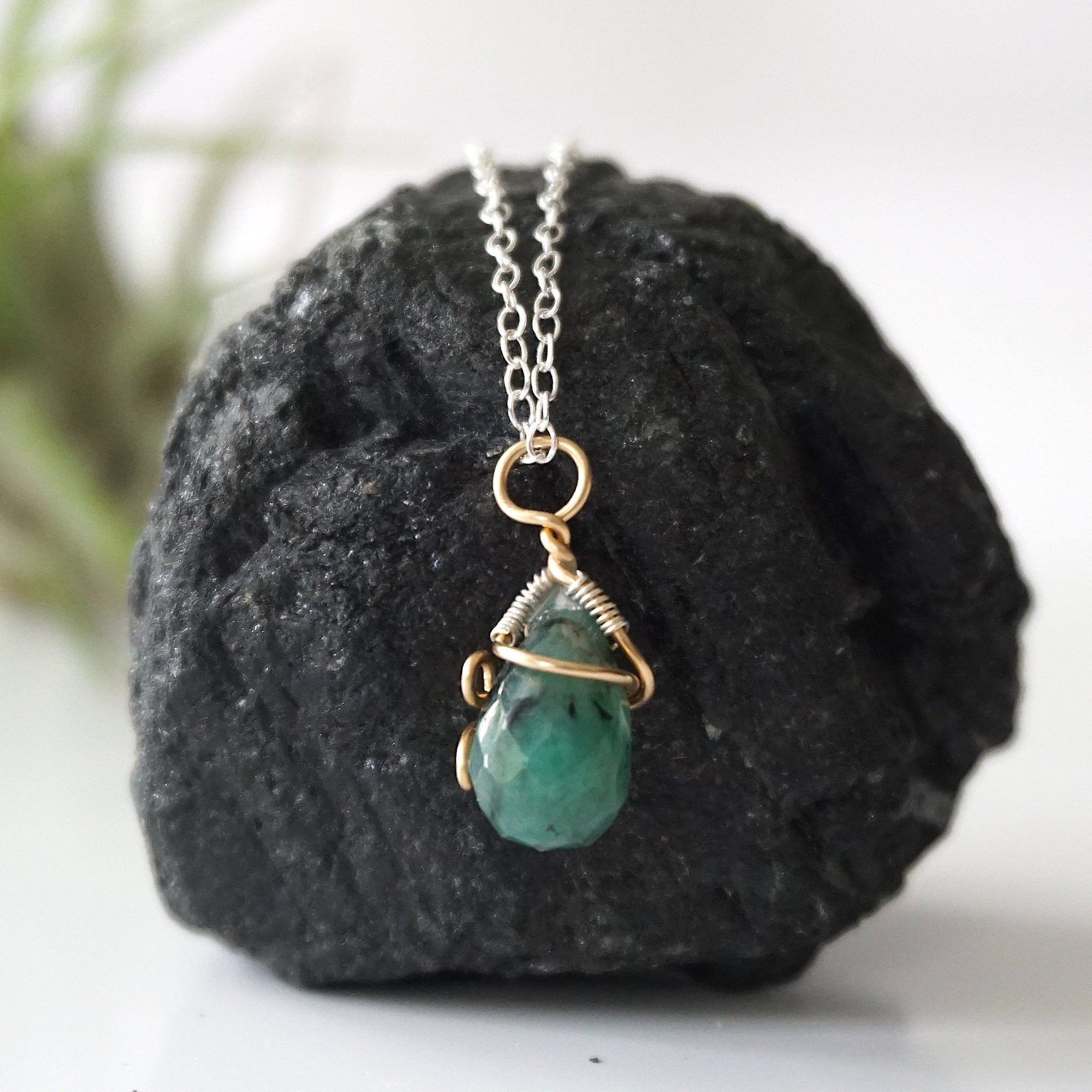 Back angle detail of minimalist emerald pendant necklace for women with natural faceted emerald and handcrafted mixed metal wrapping