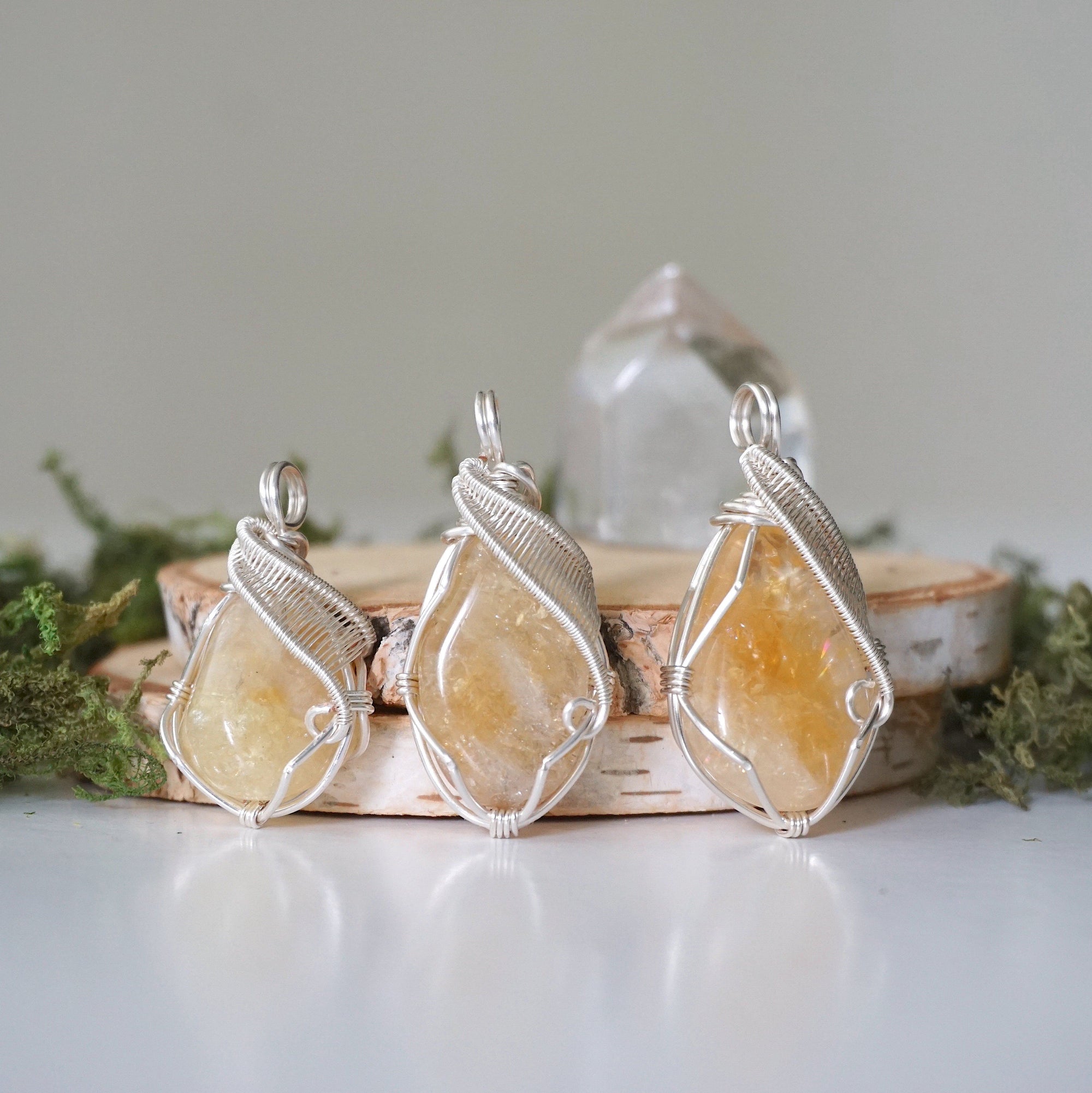 Three natural citrine crystals showing variation in color size and shape - pale yellow to golden amber unique wire wrapped silver plated pendants one of a kind