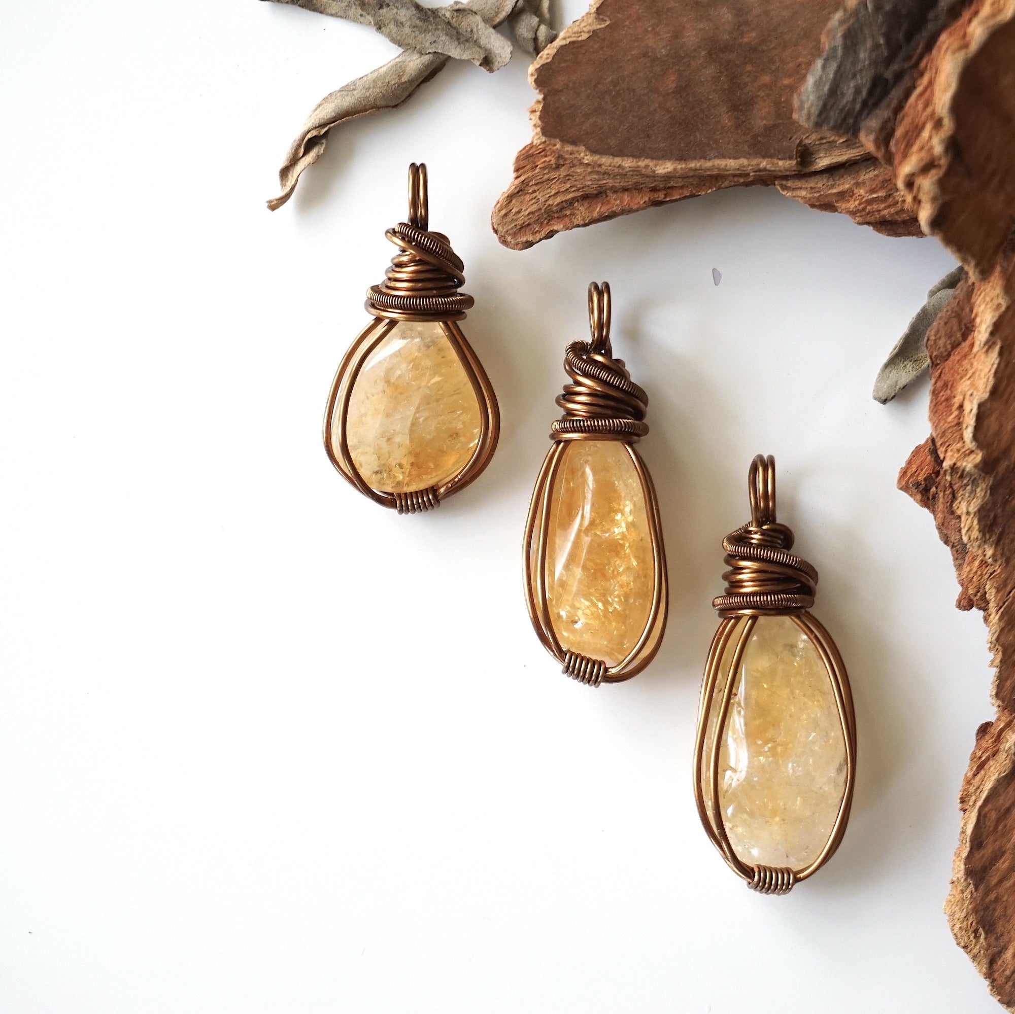 Three natural citrine crystals showing variation in color size and shape - pale yellow to golden amber unique wire wrapped antique bronze pendants unisex one of a kind