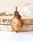 Front view of natural citrine pendant showing crystal texture and wire wrapping - antique bronze copper handmade November birthstone necklace detail vintage boho