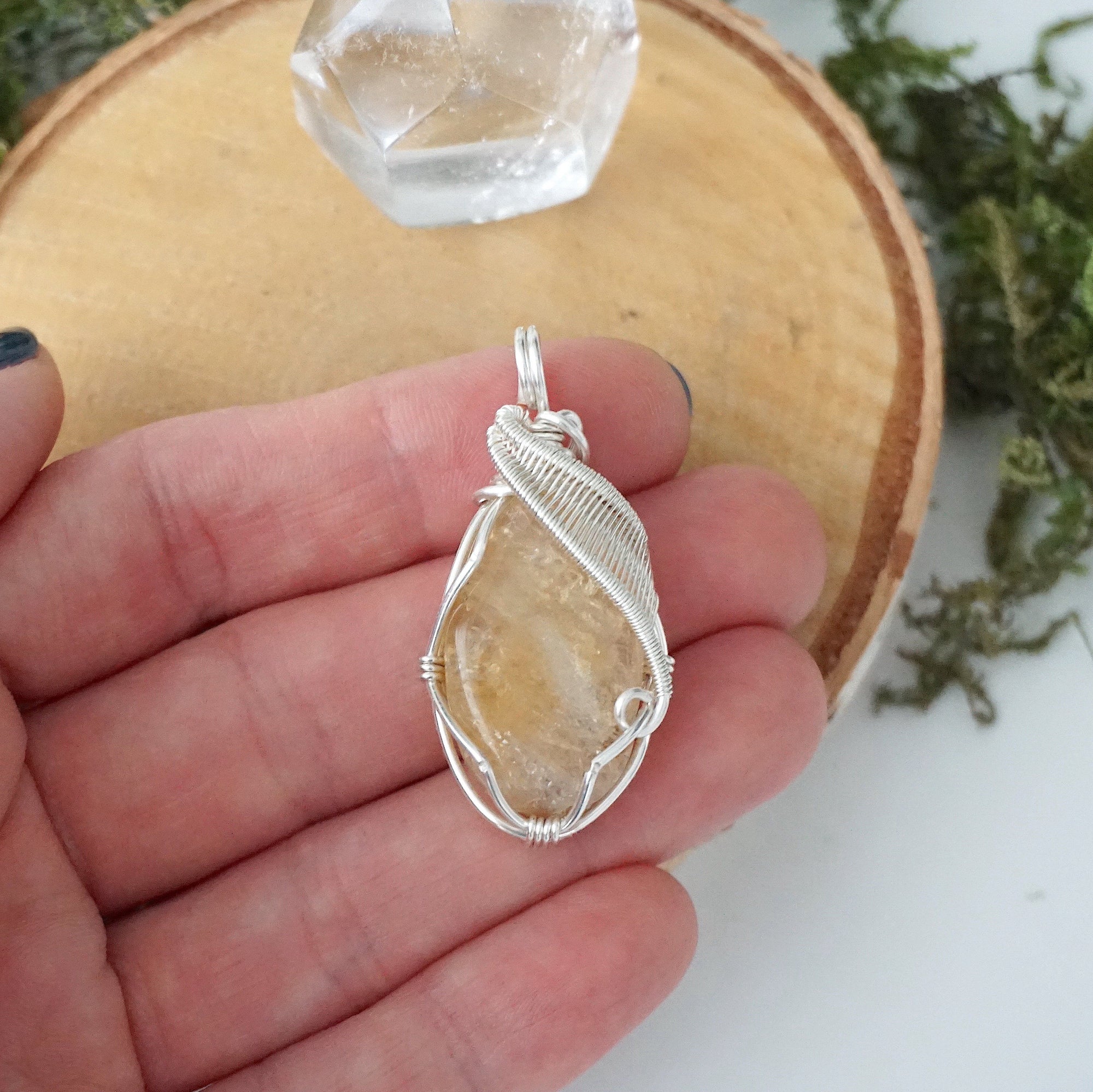 Natural citrine pendant held in hand showing size scale - wire wrapped crystal in silver plated copper handmade necklace size reference minimalist jewelry