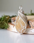 Side angle of natural citrine pendant showing crystal dimension and wire wrap detail - silver plated copper handmade minimalist necklace profile view jewelry