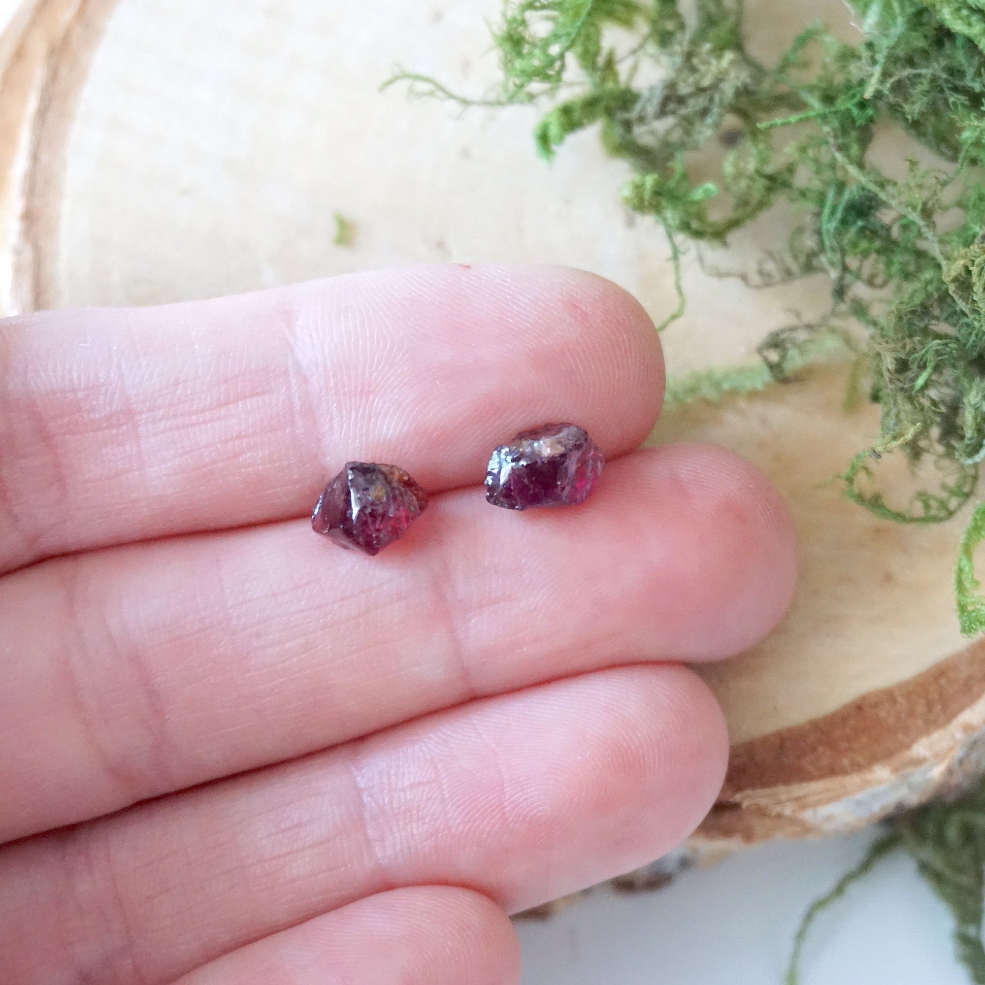 Natural garnet sterling silver stud earrings held in hand for size reference, minimalist crystal studs for everyday wear