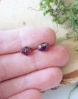 Natural garnet sterling silver stud earrings held in hand for size reference, minimalist crystal studs for everyday wear