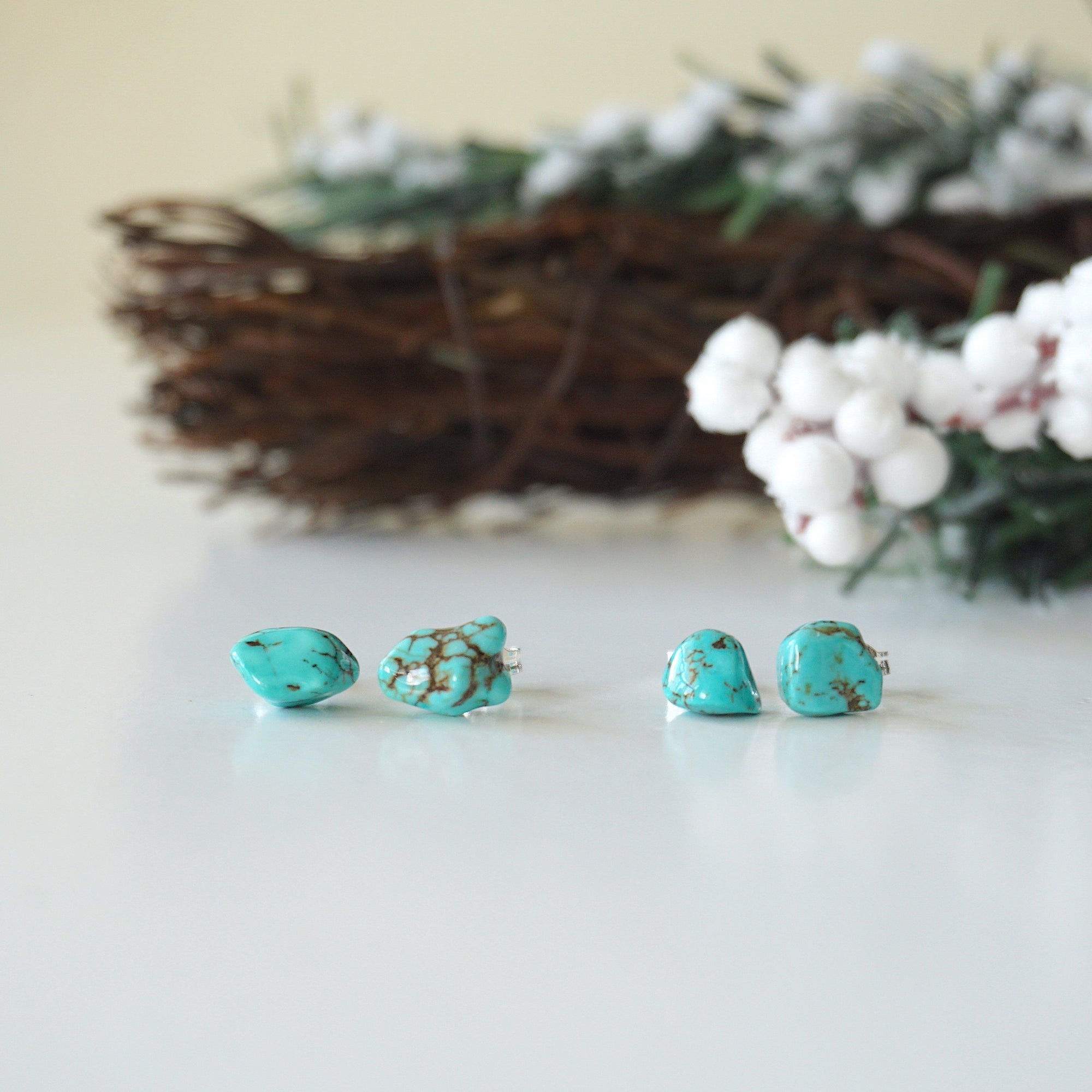 Two pairs of natural turquoise stud earrings showing unique stone variations - each handmade pair features one-of-a-kind turquoise matrix patterns