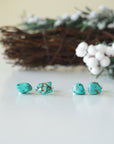 Two pairs of natural turquoise stud earrings showing unique stone variations - each handmade pair features one-of-a-kind turquoise matrix patterns