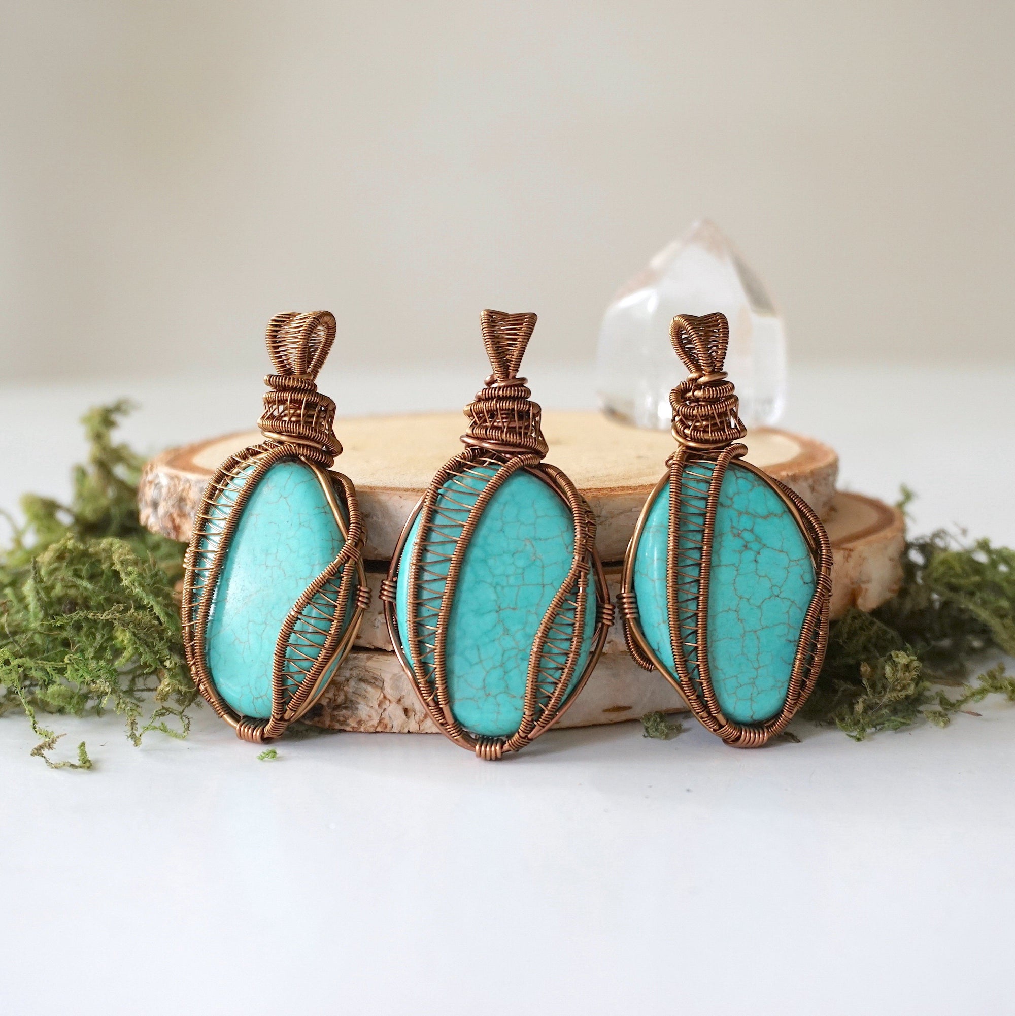 Three natural turquoise necklace pendants showing color and matrix pattern variations in authentic natural stones with bronze wire