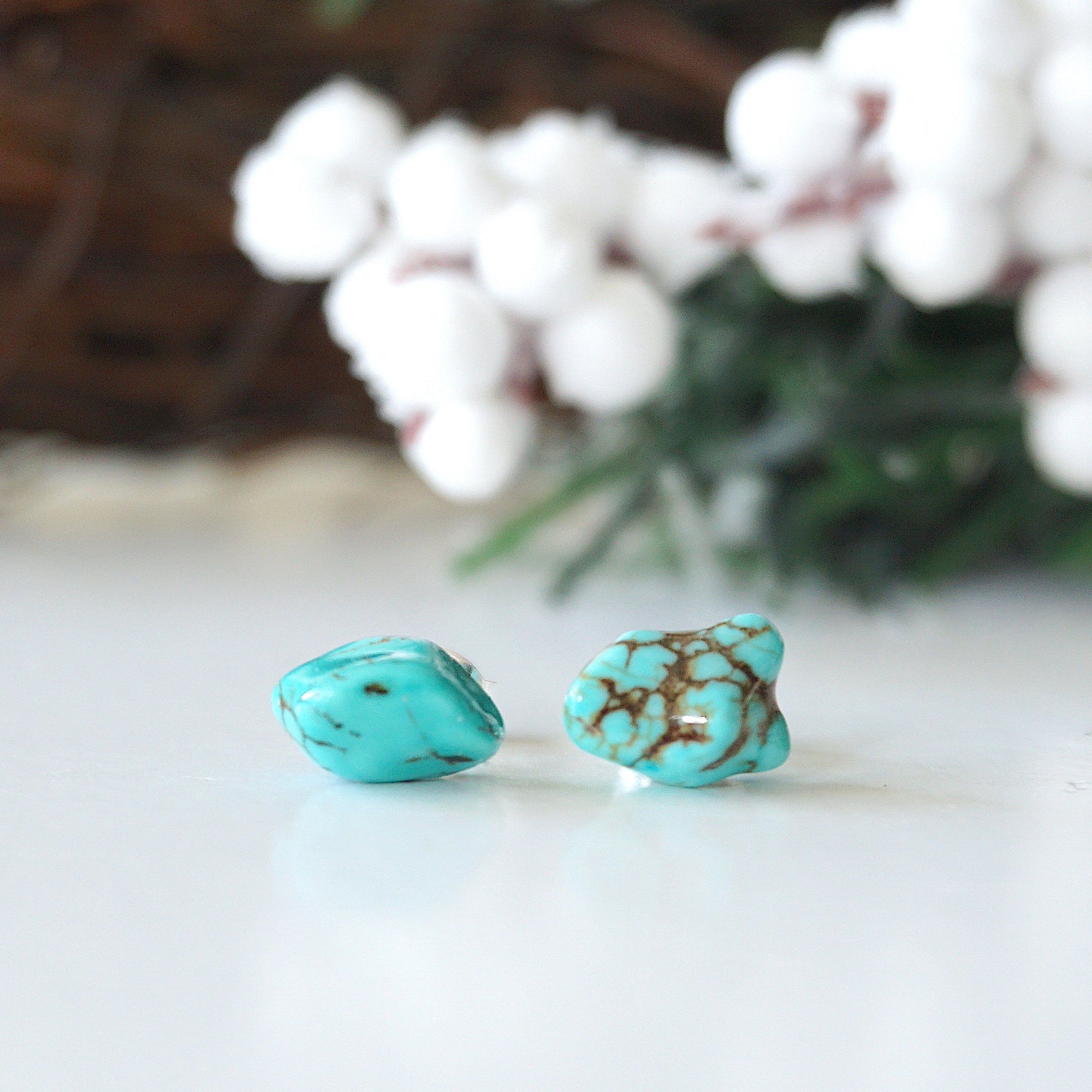 Natural turquoise stud earrings with sterling silver posts - front view showing raw turquoise stones and polished finish

