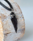 Side angle detail of men’s black obsidian arrowhead necklace, wire wrapped crystal pendant on black leather cord by Designs by Nature Gems.