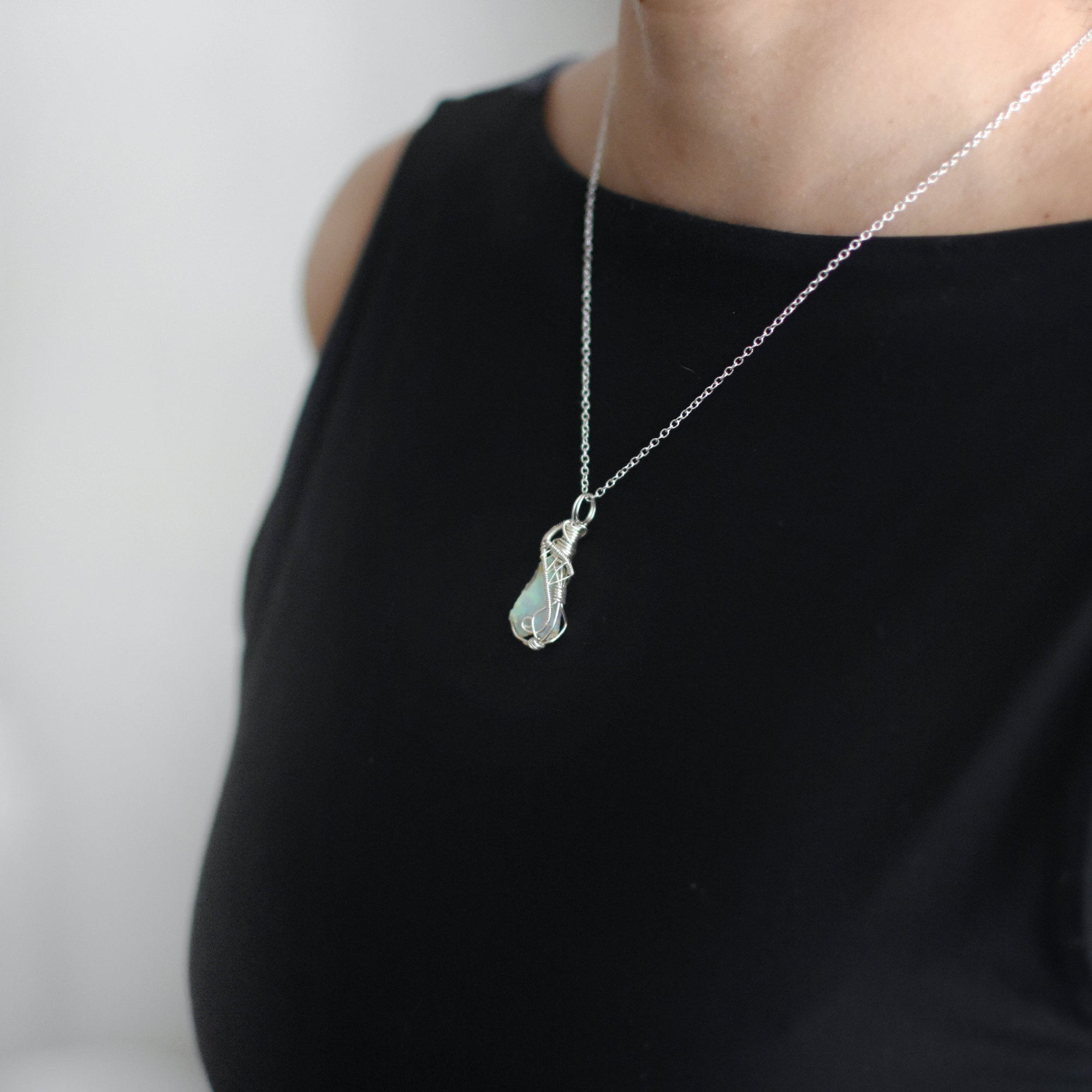 Sterling silver opal necklace on female model, artisan jewelry by Designs by Nature Gems.