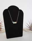 Right angle view of opal and freshwater pearl bar necklace in 925 sterling silver on jewelry display