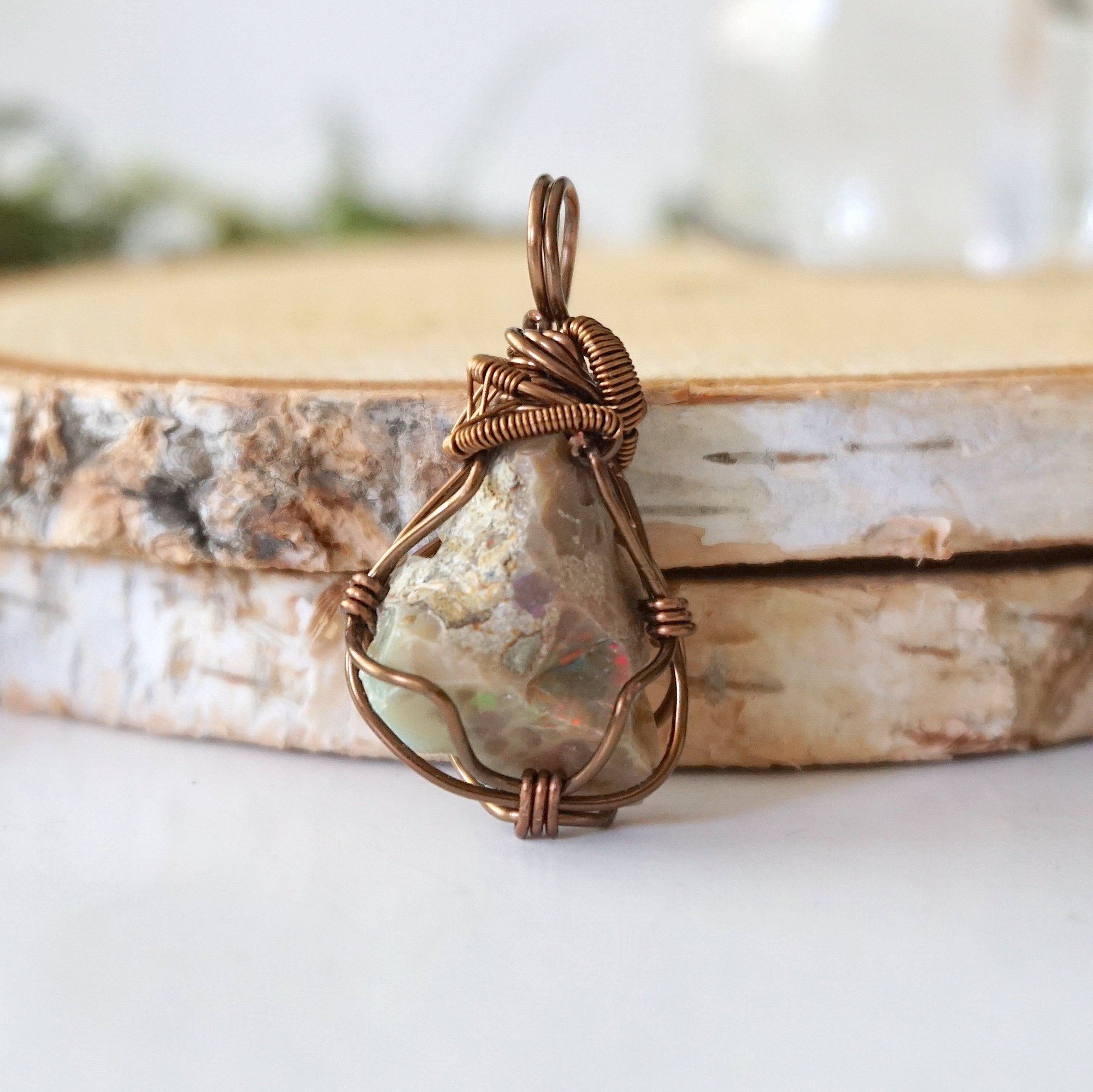 Back angle view of natural opal pendant, artisan wire wrapped jewelry by Designs by Nature Gems.