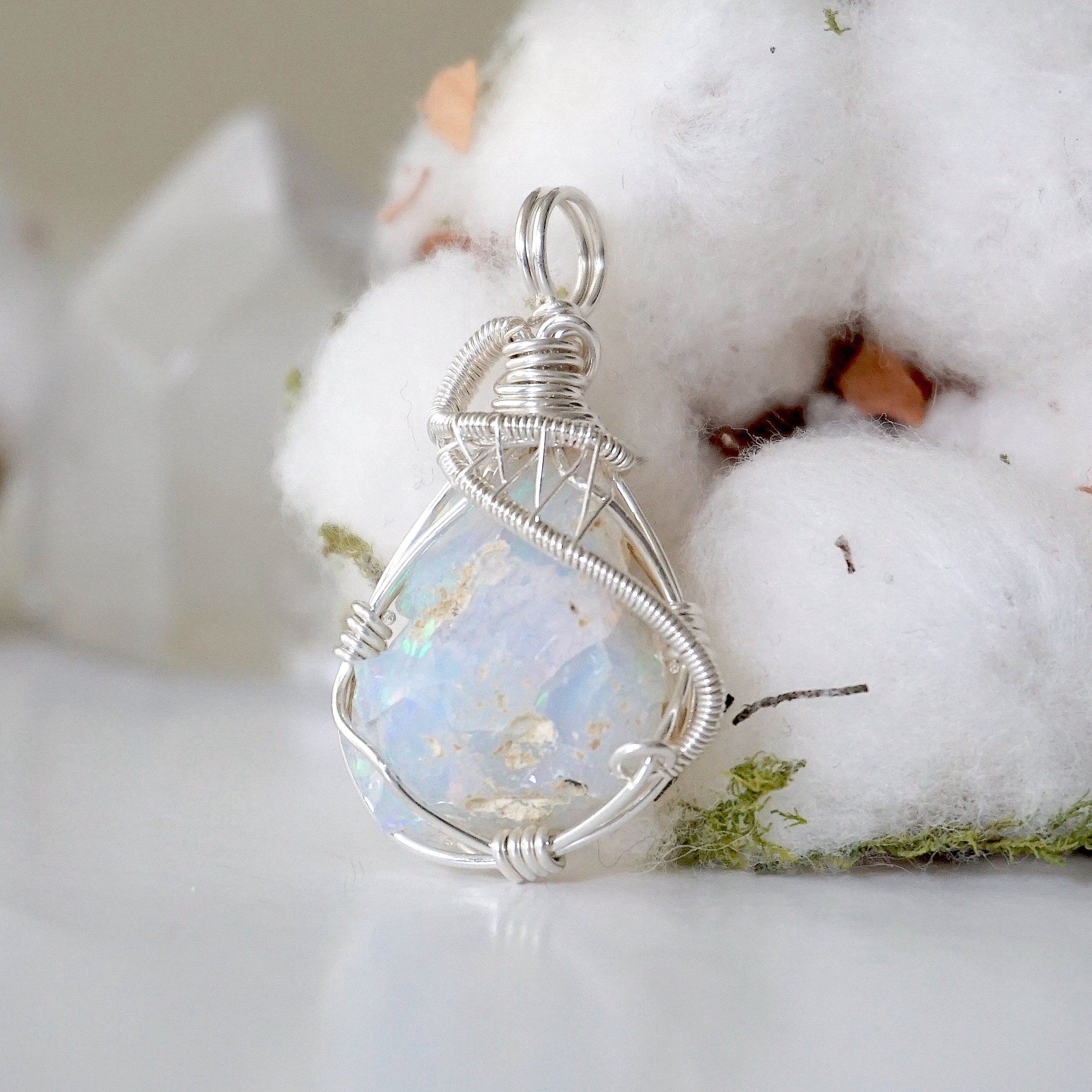 Detailed view of sterling silver opal pendant, artisan wire wrapped by Designs by Nature Gems.
